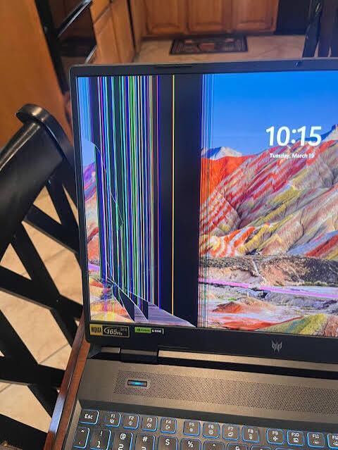 Acer Predator laptop with damaged display showing vertical lines
