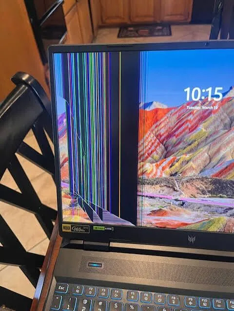 Laptop with damaged display awaiting screen replacement