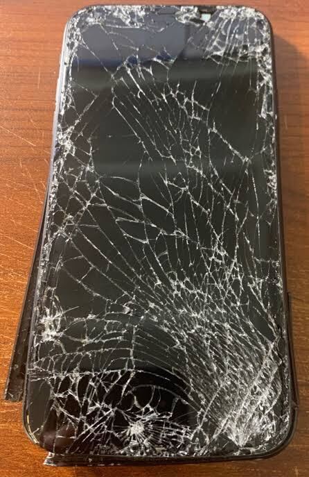 iPhone with severely cracked screen before repair